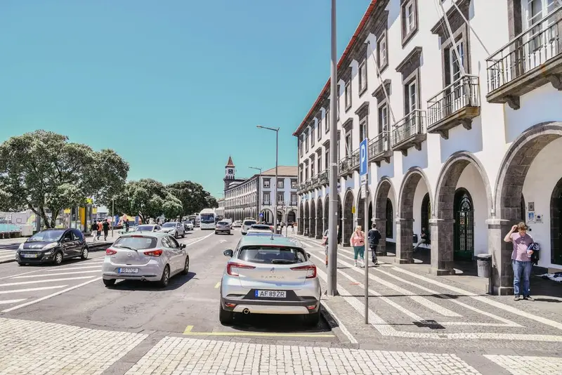Street view of Ponta Delgada with historic architecture and bustling afternoon activity.