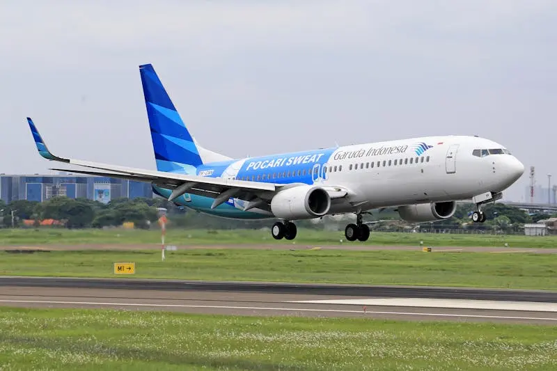 Garuda Indonesia plane taking off from a runway, showcasing modern aviation.