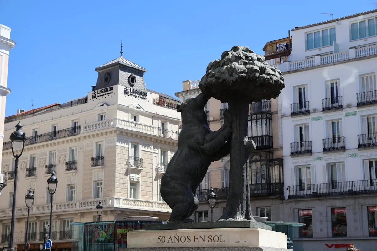 Iconic Bear and Strawberry Tree statue in Madrid's bustling Puerta del Sol.