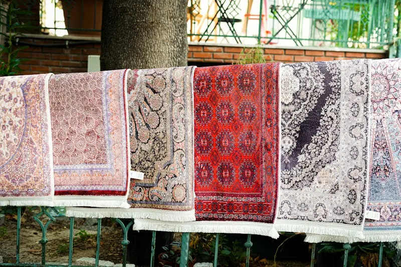 Colorful Turkish rugs displayed outdoors showcasing intricate patterns and designs.