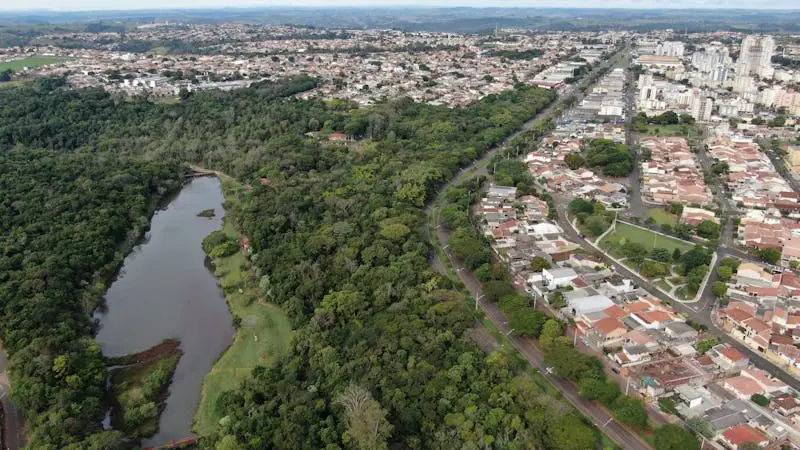 Drone shot of urban and forest landscape in Califórnia, PR, Brazil.