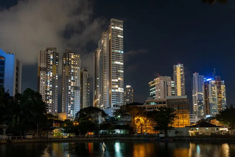 Dazzling night view of Colombo's modern skyline reflecting on a tranquil waterfront.
