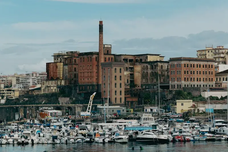 Explore the captivating blend of urban architecture and maritime scenery in Naples, Italy.