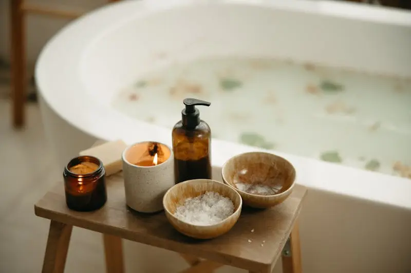 Tranquil bath setting with candles and bath salts, perfect for relaxation and beauty care.