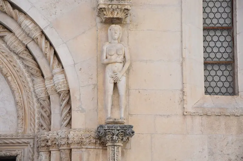 Intricate stone sculpture on a historic building facade showcasing classical architecture.