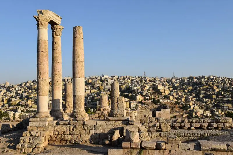 Majestic view of the Temple of Hercules ruins against Amman's sprawling cityscape.