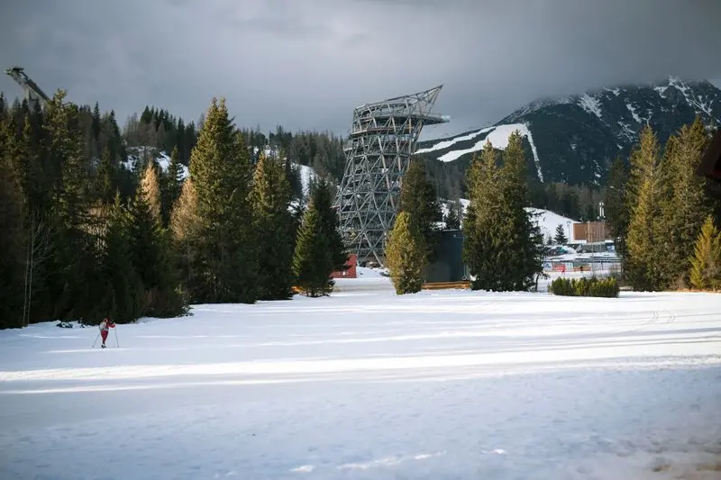 Majestic winter scene in the High Tatras with ski resort and snowy mountains.